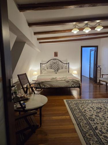 a bedroom with a bed and a table and a couch at Bucharest Boutique Accommodation by Hotels in Bucharest