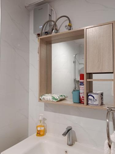a bathroom counter with a sink and a mirror at Little Haven Stays-Near UN & Two Rivers in Ruaka