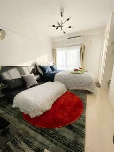 a living room with a couch and a red and white rug at BEST LOCATED SHINJUKU CENTRAL Full-Furnished APARTMENT 3minWalk to Station2 in Tokyo