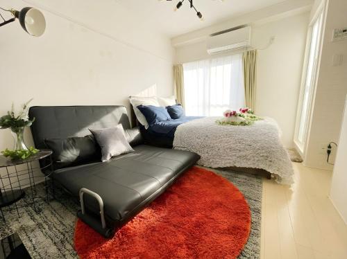 a living room with a couch and a bed at BEST LOCATED SHINJUKU CENTRAL Full-Furnished APARTMENT 3minWalk to Station2 in Tokyo