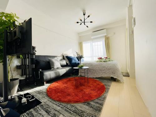 a living room with a couch and a red rug at BEST LOCATED SHINJUKU CENTRAL Full-Furnished APARTMENT 3minWalk to Station2 in Tokyo