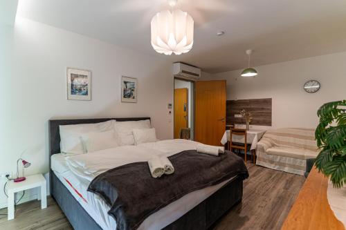 a bedroom with a large bed and a table at KJB Vendégház Dombori in Fadd-Dombori
