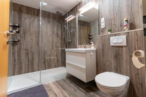 a bathroom with a toilet and a sink and a shower at KJB Vendégház Dombori in Fadd-Dombori