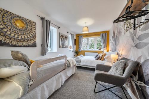 a living room with two beds and a couch at Winterbourne House in Fleet