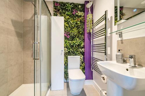 a bathroom with a toilet and a sink at Winterbourne House in Fleet
