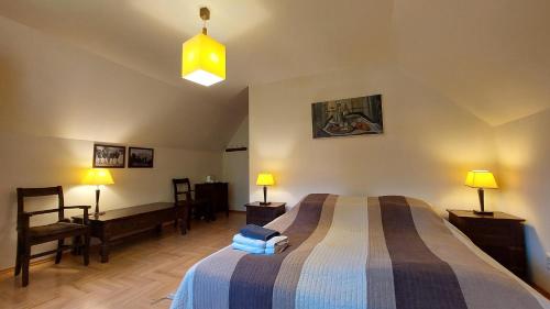 a bedroom with a bed and two lamps and a chair at Tulin in Wetlina