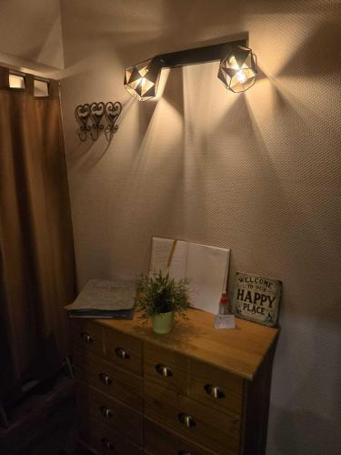 a bedroom with a dresser and lights on the wall at Ferienwohnung Salut in Saarbrücken
