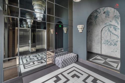 a dressing room with mirrored walls and a large mirror at The Light Home in Bucharest