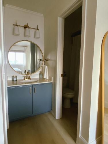 a bathroom with a sink and a mirror at Pearl on the Point in Carolina Beach