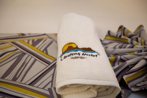 a roll of toilet paper sitting on a pile of ties at Lorateng' Resort - Rusinga in Mbita