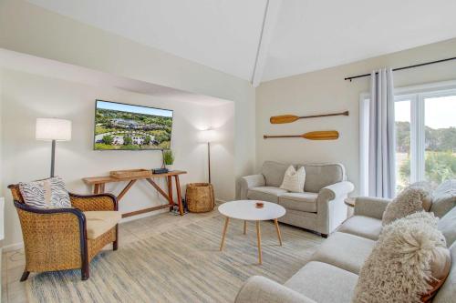 a living room with a couch and a tv at Spinnaker 753 in Seabrook Island