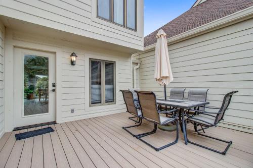 a patio with a table and chairs and an umbrella at Spinnaker 753 in Seabrook Island