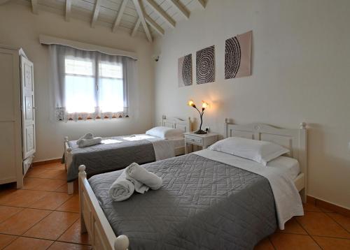 a bedroom with two beds and a window at Anatoli Villa in Steni Vala Alonissos