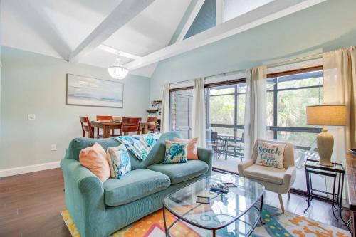 a living room with a blue couch and a glass table at Mariner's Watch 4267 in Kiawah Island
