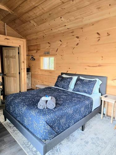 a bedroom with a bed in a log cabin at Tiny Home Big View! in Franklin