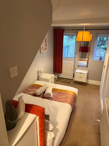 a small room with a bed in a attic at Prime location Clifton 2 bed self contained spacious garden apartment in Bristol