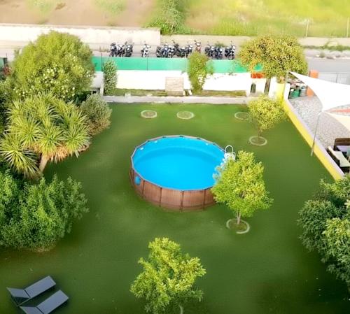 an overhead view of a garden with a swimming pool at Casa del Sole Irgoli - BIKERS HOME in Irgoli