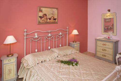 a bedroom with a bed with pink walls and flowers on it at stunning tranquil villa with private pool in Sami