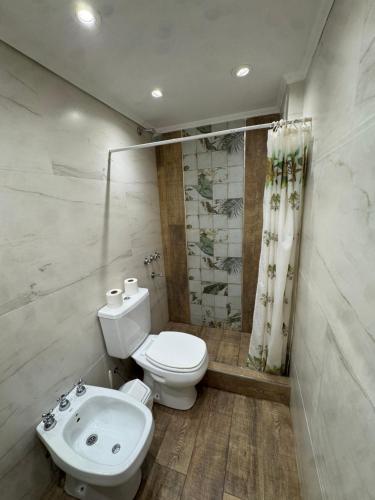 a bathroom with a toilet and a sink at Panoramico in Santa Teresita