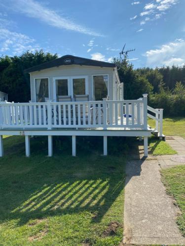 a white bench in the grass in a field at Isle of Wight Caravan in Shanklin