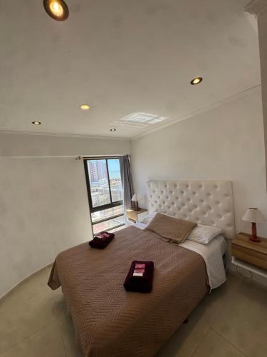 a bedroom with a large bed and a window at Panoramico in Santa Teresita