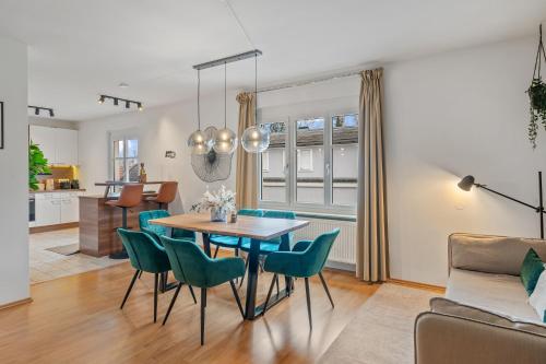 a dining room and living room with a table and chairs at dreamfactory Residences - Wine Escapes # 3BR Suite in Langenlois