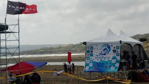a tent on the beach with a group of people at On Board Hostel in Manzhou