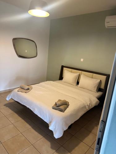 a bedroom with a bed with two towels on it at Kremasti Rooms in Kremastí