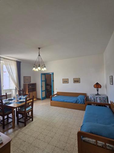 a living room with a bed and a dining room at La Casetta Sul Corso in Ischia Town