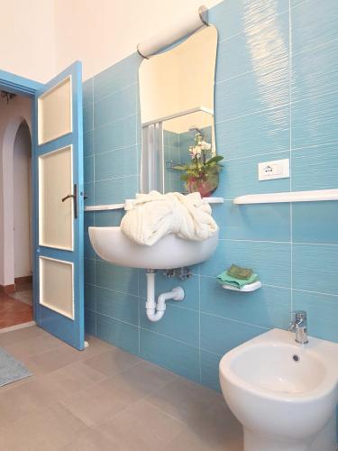 a bathroom with a sink and a mirror and a toilet at La Casetta Sul Corso in Ischia Town