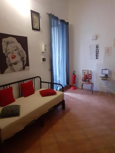 a bedroom with a bed with red pillows at Casa Normanna in Salerno