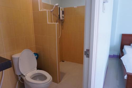 a bathroom with a toilet and a shower at Anyamanee Resort Trat in Trat