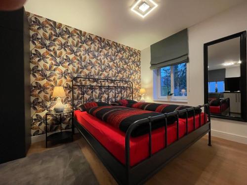a bedroom with a bed with a red couch at Ferienpark Worpswede in Worpswede