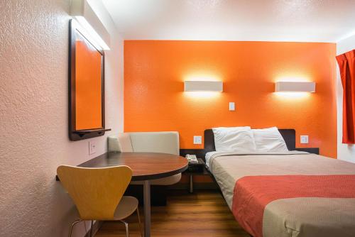 a room with a bed and a table and a bed and a room at Motel 6-Bessemer, AL - Birmingham in Bessemer