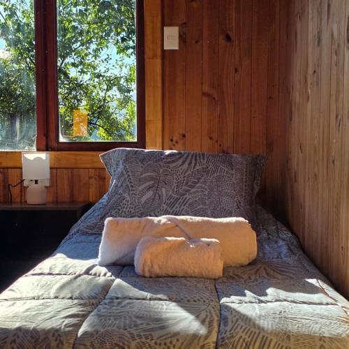 a bed in a room with two towels on it at Cabaña 2 - Rancho Doble AA in La Junta