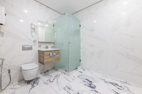 a bathroom with a toilet and a glass shower at Sky View by Luxurious Holidays in Rabat