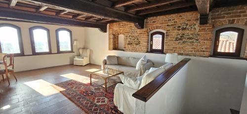 a living room with a couch and a table at Al Castello di Valdengo in Valdengo