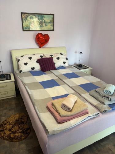 a bedroom with a bed with towels on it at Kuća na obali Save in Obrenovac