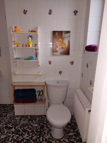 a small bathroom with a toilet and a tub at The Veterinary @ Kildare Village in Kildare