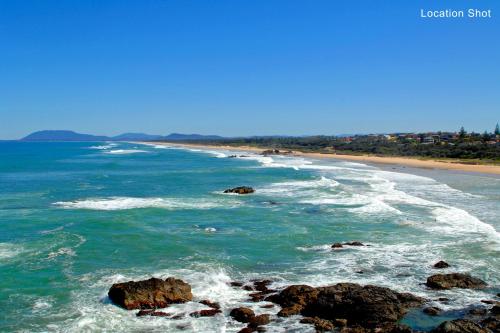 a view of a beach with rocks in the ocean at Strathmore Lodge in Port Macquarie
