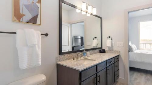 a bathroom with a sink and a mirror at Landing Stunning 2BD in Corinth in Denton