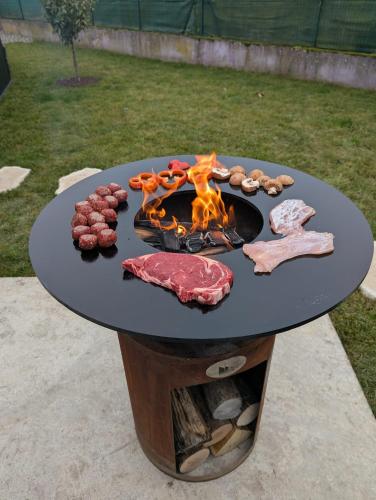 a table with meat and food on it at Gîte l'Hortensia Rose in Guémar