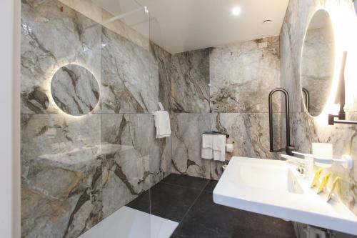 a bathroom with a stone wall at The FLOOR in Milan