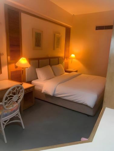 a bedroom with a bed and a desk and a chair at 1BR Seaview Condo with Balcony at Riviera Bay Resort, Melaka in Malacca
