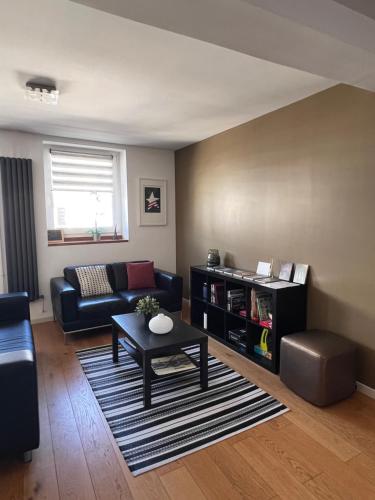 a living room with a couch and a table at Chambre d'hôte-abc in Reims