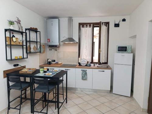 a kitchen with a table and chairs and a refrigerator at Palma's house in Cambiago