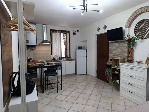 a kitchen with a table and a kitchen with white cabinets at Palma's house in Cambiago