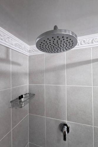 a bathroom with a shower with a light at Elite Luxe Cabin Suite in Welkom