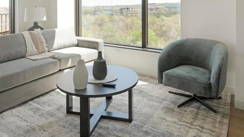 a living room with a couch and a chair and a table at Landing Stunning 2BD Pool Courtyard in Washington
