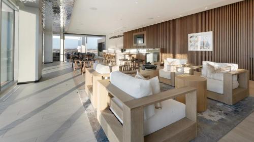 a living room with white furniture and a dining room at Landing Stunning 2BD Pool Courtyard in Washington